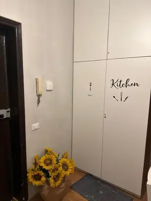 a room with flowers in a vase next to a locker at Trani B&T Rooms in Rome