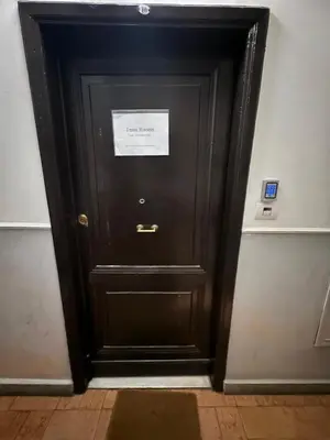 a black door in a room with a sign on it at Trani B&T Rooms in Rome