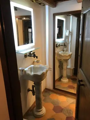 a bathroom with two sinks and a mirror at La Casa Dei Marmi in Rome