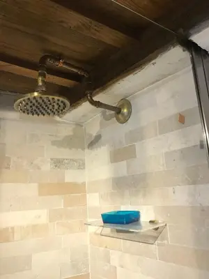 a shower with a blue bowl on a wall at La Casa Dei Marmi in Rome