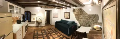a living room with a couch and a stone wall at La Casa Dei Marmi in Rome