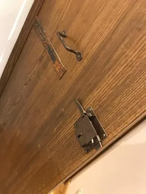 a door opener and a latch on a wooden door at La Casa Dei Marmi in Rome