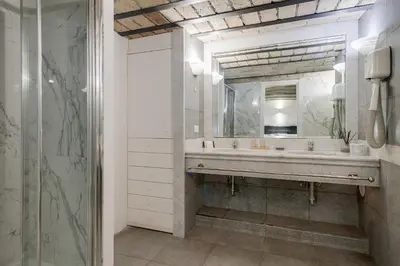 a bathroom with a sink and a mirror at Giolitti Suite in Rome