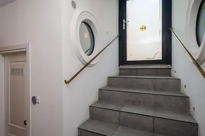 a stairway with a door and a window and a stair case at Giolitti Suite in Rome