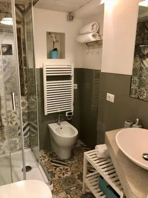a bathroom with a toilet and a shower and a sink at LeopardElla in Rome
