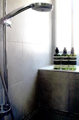 two bottles of essential oils sitting on a shelf in a bathroom at MANDRUCHELLO'S in Rome