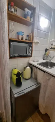 a kitchen with a counter with a toaster and a microwave at Domus next Campo de'Fiori with thermal shower in Rome