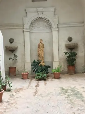 a statue of a woman in a building with plants at Domus next Campo de'Fiori with thermal shower in Rome