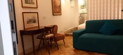 a living room with a couch and a table and chairs at Domus next Campo de'Fiori with thermal shower in Rome