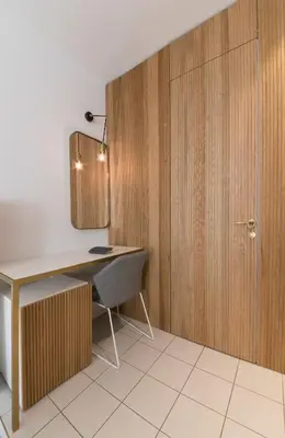 a desk and a chair in a room with a door at Horti 14 Borgo Trastevere Hotel in Rome