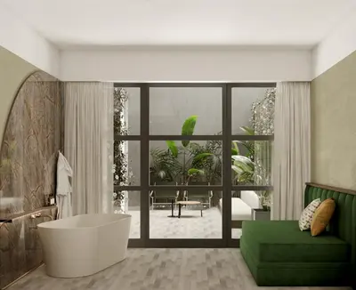 a bathroom with a tub and a green couch at Horti 14 Borgo Trastevere Hotel in Rome