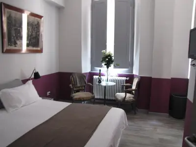 a hotel room with a bed and a table and chairs at Trastevere Colors in Rome