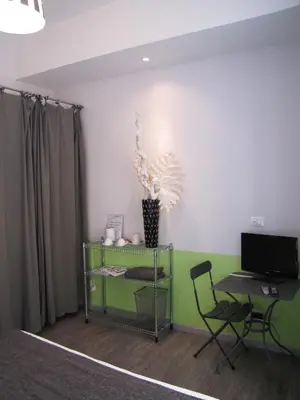 a room with a desk and a chair and a computer at Trastevere Colors in Rome