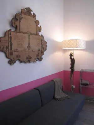 a living room with a couch and a lamp at Trastevere Colors in Rome
