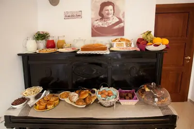 a table filled with different types of bread and pastries at Il Mondo Di Amelia in Rome