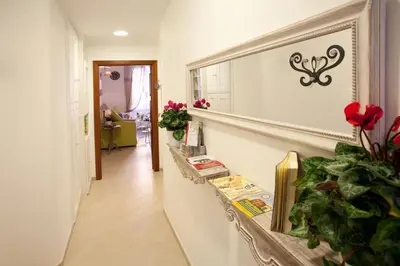 a hallway with a table and flowers on a wall at Il Mondo Di Amelia in Rome