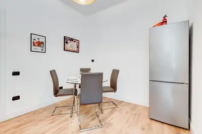 a dining room with a table and a refrigerator at Vaticano Private Apartment in Rome