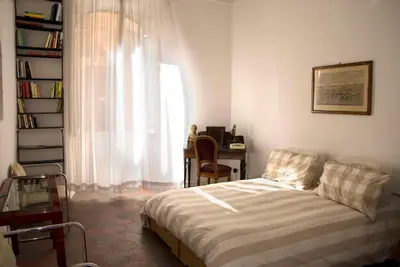 a bedroom with a bed and a desk and a window at Il Mio Giardino in Rome