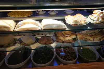 a display case filled with lots of different types of food at Il Mio Giardino in Rome