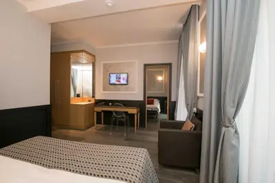 a hotel room with a bed and a bathroom at DK Suites in Rome