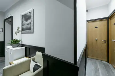 a living room with a couch and a wooden door at DK Suites in Rome