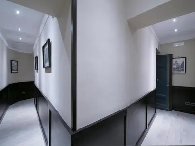 a hallway with white walls and a black door at DK Suites in Rome