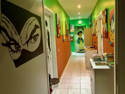 a hallway with a painting of a woman on the wall at Comics Guesthouse Hostel in Rome