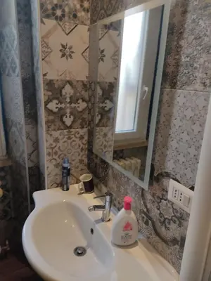 a bathroom with a sink and a mirror at Comics Guesthouse Hostel in Rome