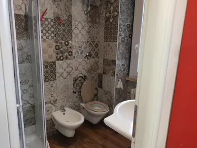 a small bathroom with a toilet and a sink at Comics Guesthouse Hostel in Rome