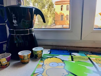 a hello kitty coffee pot and two cups on a counter at Comics Guesthouse Hostel in Rome