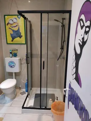 a shower stall in a bathroom with a toilet at Comics Guesthouse Hostel in Rome