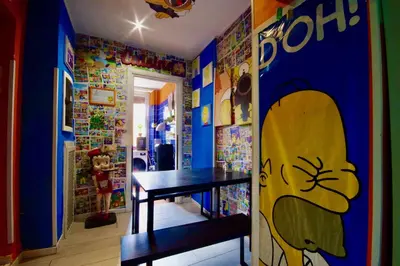 a dining room with a table with a painting on the wall at Comics Guesthouse Hostel in Rome