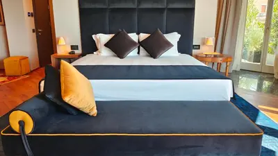 a bedroom with a large bed with a black headboard at Triviho Hotel in Rome