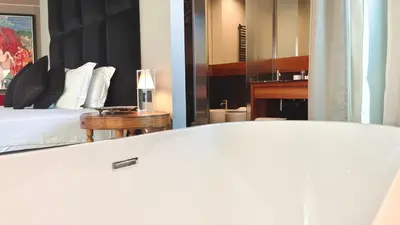 a bedroom with a bed and a table and a mirror at Triviho Hotel in Rome