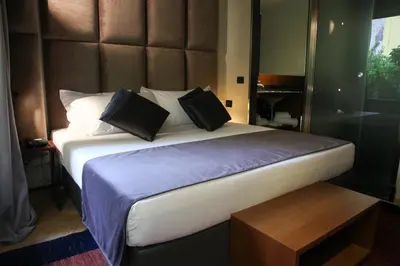 a bedroom with a large bed with pillows at Triviho Hotel in Rome