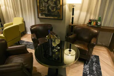 a living room with a table and leather chairs at Triviho Hotel in Rome