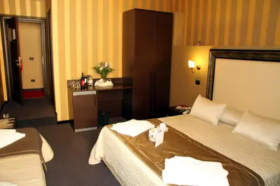 a hotel room with two beds with a cross on it at Domus RomAntica in Rome