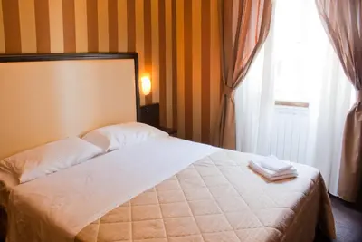 a bedroom with a bed with two towels on it at Domus RomAntica in Rome