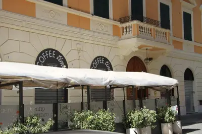 a building with two white umbrellas in front of it at Domus RomAntica in Rome