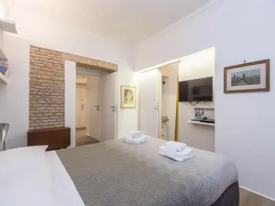 a bedroom with a bed with two towels on it at Apartment Forum Augusti by Interhome in Rome