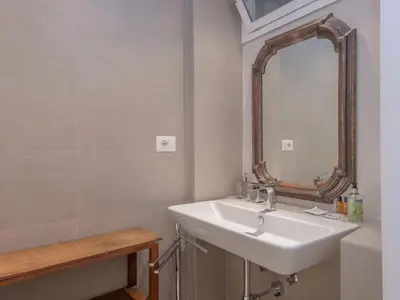 a bathroom with a sink and a mirror at Apartment Forum Augusti by Interhome in Rome
