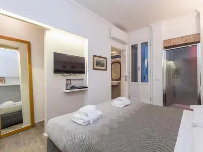 a bedroom with a bed and a tv on a wall at Apartment Forum Augusti by Interhome in Rome