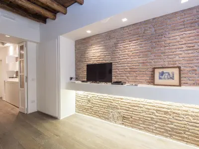 a brick wall with a flat screen tv at Apartment Forum Augusti by Interhome in Rome