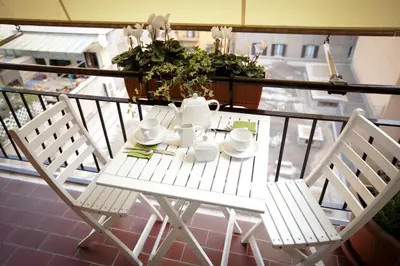 a white table and chairs on a balcony at Castellani A San Pietro in Rome