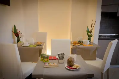 a room with a table and chairs with food on it at Castellani A San Pietro in Rome