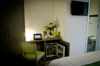 a room with a bed and a table and a chair at Castellani A San Pietro in Rome