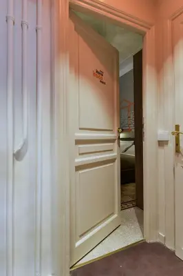 a white door with a sign on it in a room at The Pope's Window in Rome