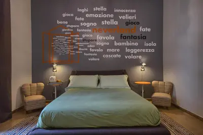 a bedroom with a bed with words on the wall at The Pope's Window in Rome