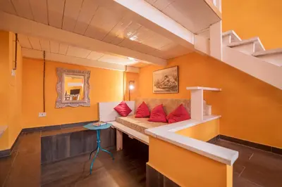 a room with a couch with red pillows on it at Quirinale Apartments in Rome