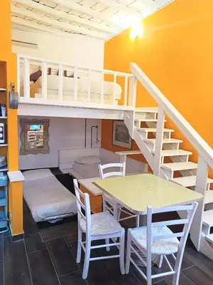 a room with a bunk bed and a table and stairs at Quirinale Apartments in Rome